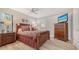 This primary bedroom boasts a ceiling fan, an entertainment center, and wood-look floors at 4009 Crockers Lake Blvd # 22, Sarasota, FL 34238