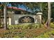 Elegant community sign amid colorful flowers and manicured landscaping at 4009 Crockers Lake Blvd # 22, Sarasota, FL 34238