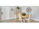 Cozy dining area with a round table, four chairs, decorative cabinet and a neutral color scheme at 4009 Crockers Lake Blvd # 22, Sarasota, FL 34238