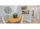 Dining area with a round table, four chairs, and pass through view into the kitchen at 4009 Crockers Lake Blvd # 22, Sarasota, FL 34238