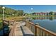 Wooden dock extends into a calm lake with condominiums in the background at 4009 Crockers Lake Blvd # 22, Sarasota, FL 34238