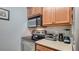 Cozy kitchen featuring stainless steel appliances, wood cabinets, and light countertops at 4009 Crockers Lake Blvd # 22, Sarasota, FL 34238