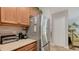 Corner kitchen view features stainless steel refrigerator and beige countertops at 4009 Crockers Lake Blvd # 22, Sarasota, FL 34238