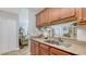Modern kitchen featuring granite countertops, stainless steel sink, and a pass-through to the living room at 4009 Crockers Lake Blvd # 22, Sarasota, FL 34238
