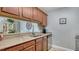 A well-equipped kitchen featuring granite countertops, stainless steel appliances, and wooden cabinets at 4009 Crockers Lake Blvd # 22, Sarasota, FL 34238