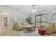 Inviting living room with comfortable seating, a ceiling fan, sliding doors, and neutral tile flooring at 4009 Crockers Lake Blvd # 22, Sarasota, FL 34238