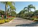 Well-maintained community street lined with palm trees and colorful shrubs at 4009 Crockers Lake Blvd # 22, Sarasota, FL 34238