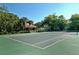 Community tennis court with a gazebo and mature trees at 4009 Crockers Lake Blvd # 22, Sarasota, FL 34238