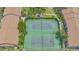 Aerial view of well-maintained tennis courts surrounded by lush landscaping at 4009 Crockers Lake Blvd # 22, Sarasota, FL 34238