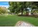 Expansive backyard with lush green grass, mature trees, and recreational area for outdoor enjoyment at 4015 Lake Bayshore Dr # 108, Bradenton, FL 34205