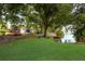 Scenic backyard with lush lawn, lake access, and kayak storage, offering a tranquil outdoor experience at 4015 Lake Bayshore Dr # 108, Bradenton, FL 34205