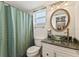 Bathroom with a unique glass bowl sink, and shower behind a curtain. It's cozy and functional at 4015 Lake Bayshore Dr # 108, Bradenton, FL 34205