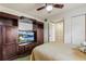 Bedroom featuring an entertainment center, TV, and closet, with a cozy, inviting atmosphere at 4015 Lake Bayshore Dr # 108, Bradenton, FL 34205