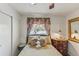 Bedroom featuring bed with decorative pillows, side table, floral curtains, and a view to the lake at 4015 Lake Bayshore Dr # 108, Bradenton, FL 34205