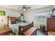 Inviting bedroom featuring a ceiling fan, wooden furniture, and a view of the lake through the window at 4015 Lake Bayshore Dr # 108, Bradenton, FL 34205