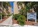 Clubhouse sign surrounded by lush landscaping, offering a glimpse of the community's amenities at 4015 Lake Bayshore Dr # 108, Bradenton, FL 34205