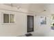 Ground floor entrance featuring storm door, windows and security camera at 4015 Lake Bayshore Dr # 108, Bradenton, FL 34205