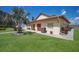 Exterior view of the community clubhouse featuring a well-manicured lawn and landscaping at 4015 Lake Bayshore Dr # 108, Bradenton, FL 34205