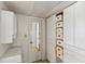 Bright hallway with tile flooring and white cabinets offering ample storage space at 4015 Lake Bayshore Dr # 108, Bradenton, FL 34205