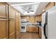 Bright kitchen featuring white appliances and light wood cabinets at 4015 Lake Bayshore Dr # 108, Bradenton, FL 34205