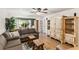 Living room featuring wood floors, a ceiling fan, and an antique cabinet with white doors and drawer fronts at 4015 Lake Bayshore Dr # 108, Bradenton, FL 34205