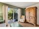 Bright living room with backyard views featuring a plush chair, a wooden cabinet, and sliding glass doors at 4015 Lake Bayshore Dr # 108, Bradenton, FL 34205
