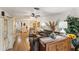 Open-concept living room with wood floors, comfortable furniture, and an open view to the kitchen and dining area at 4015 Lake Bayshore Dr # 108, Bradenton, FL 34205