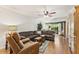 Spacious living room with wood floors, a ceiling fan, comfortable furniture, and sliding doors to a patio at 4015 Lake Bayshore Dr # 108, Bradenton, FL 34205