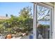 Outdoor patio with lush landscaping and a partial view of the neighborhood lake at 4015 Lake Bayshore Dr # 108, Bradenton, FL 34205