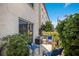 Private patio with comfortable seating surrounded by lush greenery and a view of the building at 4015 Lake Bayshore Dr # 108, Bradenton, FL 34205