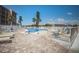 Outdoor pool surrounded by lounge chairs and a white fence, perfect for relaxation and recreation at 4015 Lake Bayshore Dr # 108, Bradenton, FL 34205