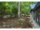 Partial view of a backyard featuring a chain link fence and mature trees at 4233 Abaco Ct, New Port Richey, FL 34653