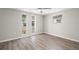 Bright bedroom featuring three large windows that allow ample natural light, and wood laminate flooring at 4233 Abaco Ct, New Port Richey, FL 34653