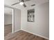 Bedroom featuring wood laminate flooring and natural light, leading to another room through an open doorway at 4233 Abaco Ct, New Port Richey, FL 34653