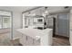 Modern kitchen with stainless steel appliances and a central island with quartz countertops at 4233 Abaco Ct, New Port Richey, FL 34653