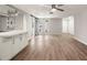 Spacious living area with wood floors leading to a kitchen, showcasing an open design at 4233 Abaco Ct, New Port Richey, FL 34653