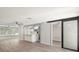Open-concept living space with wood-look floors, ceiling fans, and bright natural light at 4233 Abaco Ct, New Port Richey, FL 34653