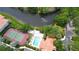 Scenic aerial view of the community pool, tennis courts and tranquil waterway at 4264 Central Sarasota Pkwy # 116, Sarasota, FL 34238