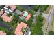 Aerial view showcasing amenities like the pool and tennis courts, surrounded by lush trees at 4264 Central Sarasota Pkwy # 116, Sarasota, FL 34238