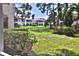 Beautiful backyard view of lawn, landscaping and other buildings in community at 4264 Central Sarasota Pkwy # 116, Sarasota, FL 34238