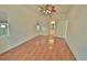 Bright bedroom with wood flooring and a view of the kitchen through an open door at 4264 Central Sarasota Pkwy # 116, Sarasota, FL 34238