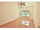A bright bedroom has hardwood floors and a window at 4264 Central Sarasota Pkwy # 116, Sarasota, FL 34238