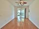 A bedroom has hardwood floors and sliding doors to the screened porch at 4264 Central Sarasota Pkwy # 116, Sarasota, FL 34238