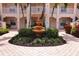 Picturesque courtyard with a tiered fountain, lovely landscaping, and brick-paved walkway at 4264 Central Sarasota Pkwy # 116, Sarasota, FL 34238