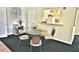 Cozy dining area with a round glass table and decorative metal chairs next to the kitchenette at 4264 Central Sarasota Pkwy # 116, Sarasota, FL 34238