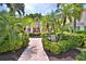 Beautifully landscaped entrance to building featuring lush greenery and a charming fountain at 4264 Central Sarasota Pkwy # 116, Sarasota, FL 34238