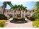 Well-maintained building featuring a fountain, manicured landscaping, and charming exterior details at 4264 Central Sarasota Pkwy # 116, Sarasota, FL 34238