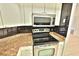 Efficient kitchen features white cabinets, stainless steel appliances, and durable countertops at 4264 Central Sarasota Pkwy # 116, Sarasota, FL 34238