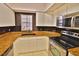 Features of the kitchen include white cabinets, stainless steel appliances, and granite countertops at 4264 Central Sarasota Pkwy # 116, Sarasota, FL 34238
