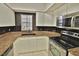 Features of the kitchen include white cabinets, stainless steel appliances, and granite countertops at 4264 Central Sarasota Pkwy # 116, Sarasota, FL 34238